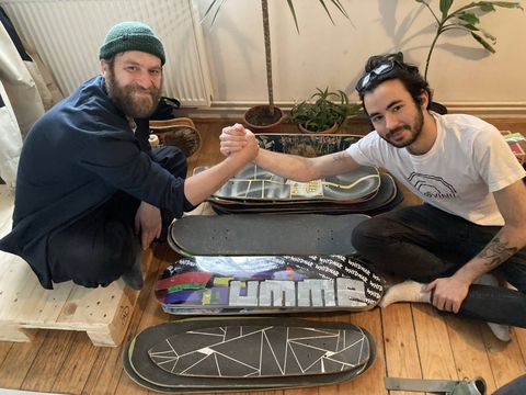 A friendly handshake over the skate decks.